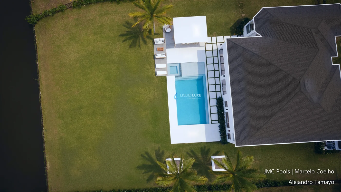 Top view of the 20' x 40' pool with sunshelf and spa, the pergola and outdoor kitchen next to the house
